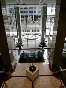 Looking down from the '+15' walkway to the foyer of one of the skyscrapers