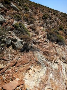 Up rocks and onto a rough path towards the col