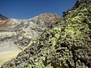 Clusters of sulphur-encrusted fumaroles line the rocky sides of Polyvotis
