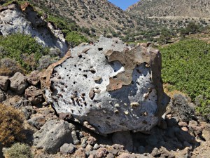 Lava boulders scattered around, the bulldozed track clear in the background