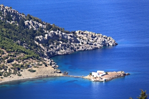 Looking down from the shoulder of the hill to Skoumisa Bay and the island monastery of Agios Emilianos 