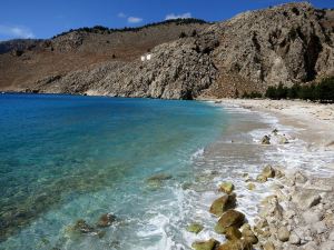 Looking along the beach towards the monastery perched on the cliff