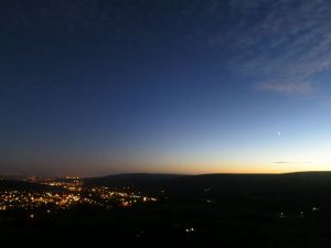 Dark in the valley, last glimmer of sunset beyond the ridge to the West