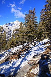 Photographer on the wind-stripped looking towards Cascade Mountain