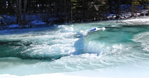 Thick ice forms over the rocks on the rapids