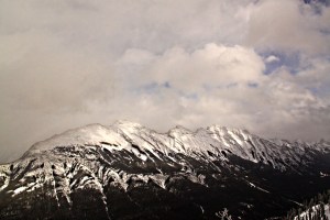 The serrated peaks of Rundle Mountain briefly lit by the sun