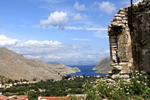 On the way out of the village towards the path to Pedi Bay ruined buildings host wild flowers and offer great views