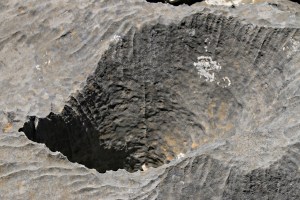 A large serrated-edged hole in the rock