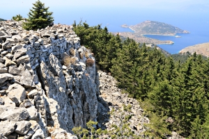 Castle walls on top of the crag, Agios Emilianos island monastery in the distance