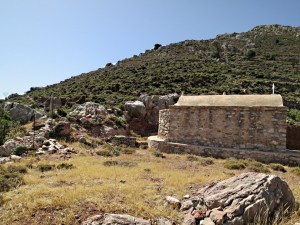 The onward path climbs up the rocks behind the chapel