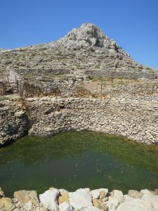 Looking across the pond to the crag behind