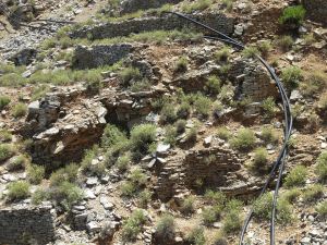 Black polypropylene pipes draped across the landscape, heating the water as it goes