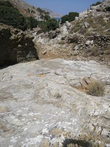 Looking down the final drop, a broad slab with the sea now in view.