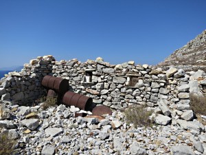 Ruins of house with ornamental oil drums