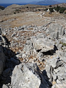 Looking down the rocky outcrop to cut off a bend in the road