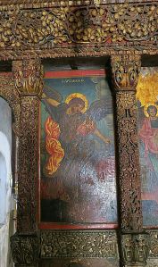 One of the panels in the iconastis, this one depicting the Archangel Michael, edged by fine wood carving 