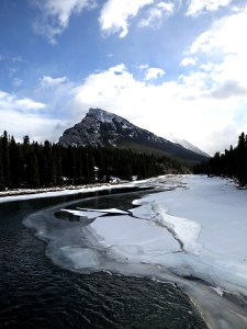 Looking downstream from the new footbridge over the Bow River towards Mount Rundle, more open water than usual, ice breaking up