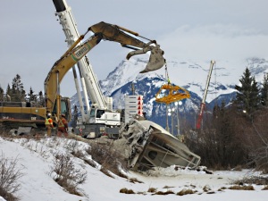 Derailed and split wagon with large-scale equipment above
