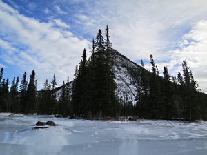 Looking across shiny ice to Rundle Mountian, the ice having collapsed as the river level lowered