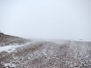 Fine snow being swirled off the top by strong wind