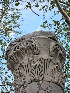 Carving still in place on top of column
