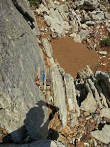 Photographer scratching his head wondering how to get down the edge of the strata in this chute
