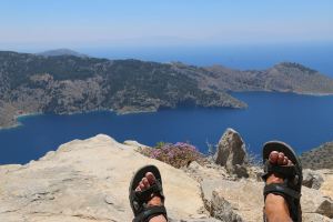 Taking it easy on the rock slabs below the castle looking down to Agios Vasilios Bay