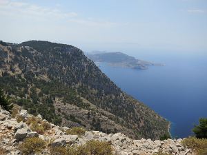 View from the compound of Stavros Polemou with Megalos Sotoris further along the cliffs and Panormitis with its large bay in the distance