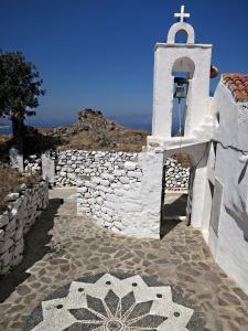 The monastery at the highest point, with spiral stairs and hochlakos (pebble mosaic) pattern in the courtyard