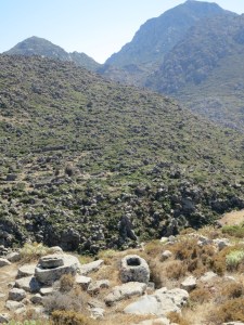 High in the col between two caldera, the top of a cistern covered by a stone and a small basin carved out of rock  People lived here.