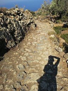 Photographer  with  an example of well preserved and recently maintained paved kalderimi (mule track)
