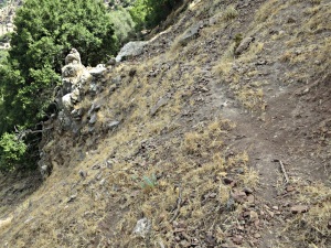 Narrow trail across steeply inclined loose volcanic shale