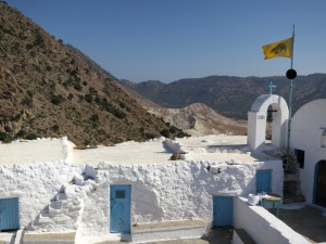 View across the courtyard of Agios Stavros monastery, the top of the Alexandros crater just beyond, Stephanos out of sight below