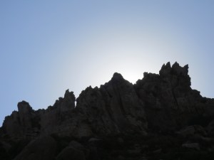 The sun still low in a September sky, silhouettes the jagged ridgeline