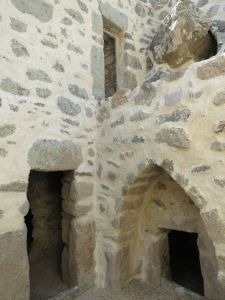 Three entrances:  bottom right the original cave dwelling; bottom right the ‘downstairs’ room; a larger family room built over the top