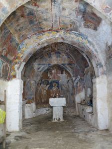 The Siones chapel, walls and ceiling covered in fresco.  Further damage to the frescoes has been prevented by repair to the arched roof.
