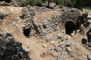 Semi-detached under-terrace houses.  The stonework on the front of the one on the left has partly collapse showing the depth of the soil above which is part of the agricultural terrace.