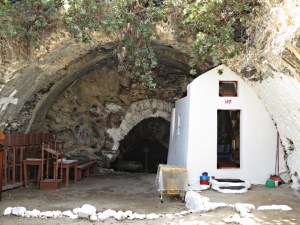 Down the steps and inside, the tiny church built into the rock under the remains of a terracotta domed roof , the spring in the cave behind