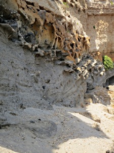 ..... the multicoloured pumice in the cliff eroded into weird shapes